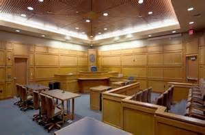 A courtroom in the Dane County Courthouse. The Walk of Shame by The Rejected runs from the jury panel on the right between the prosecutor and defense tables in the middle.