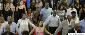 CHARLESTON, SC - JUNE 21: Parishioners embrace as they attend the first church service four days after a mass shooting that claimed the lives of nine people at the historic Emanuel African Methodist Church June 21, 2015 in Charleston, South Carolina. Chruch elders decided to hold the regularly scheduled Sunday school and worship service as they continue to grieve the shooting death of nine of its members including its pastor earlier this week. (Photo by David Goldman-Pool/Getty Images)