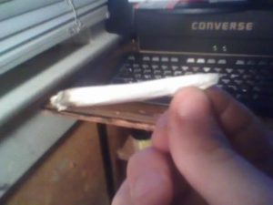 A hand rolled cigarette. Judging from the typewriter in the background, I'd say this is an old photo. [Internet photo]